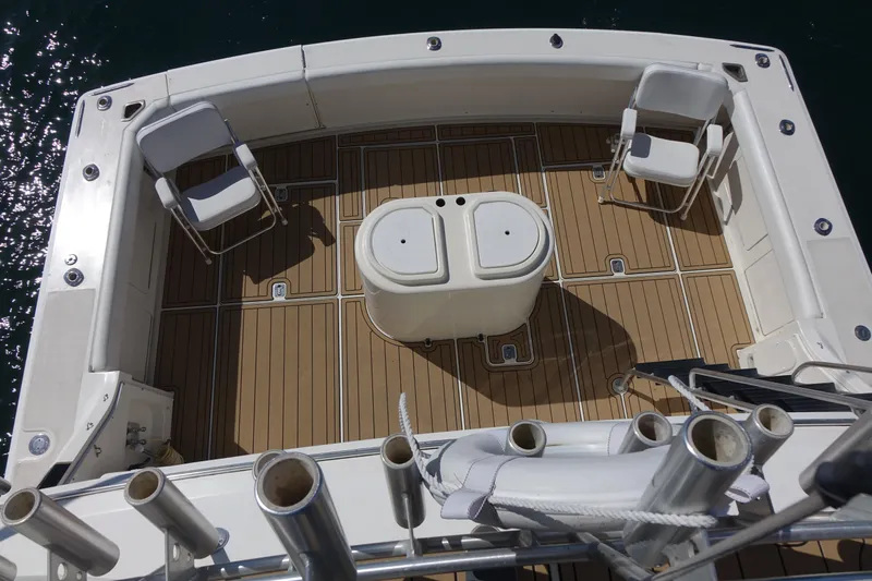 Aquila II Yacht Photos Pics Bertram 50 Convertible 1990 boat deck with chairs and storage unit.
