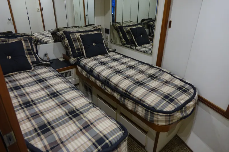 Aquila II Yacht Photos Pics Twin beds in a 1990 Bertram 50 Convertible yacht cabin with plaid bedding.