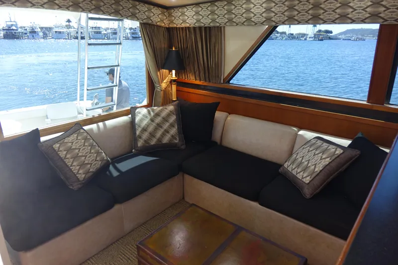 Aquila II Yacht Photos Pics Luxurious interior of a 1990 Bertram 50 Convertible yacht with elegant seating and ocean view.