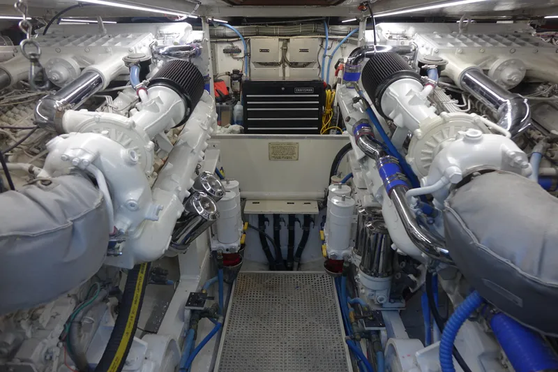 Aquila II Yacht Photos Pics Engine room of a 1990 Bertram 50 Convertible yacht, featuring dual engines and organized layout.