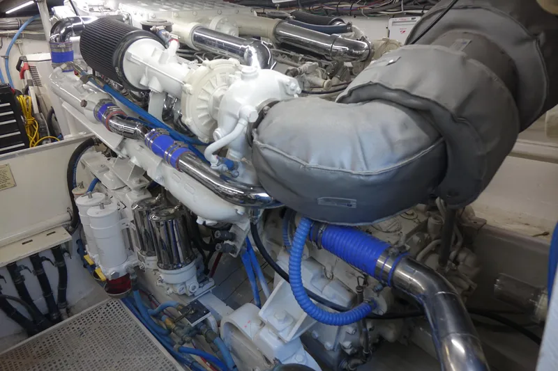 Aquila II Yacht Photos Pics Engine room of a 1990 Bertram 50 Convertible yacht, showcasing detailed machinery and components.