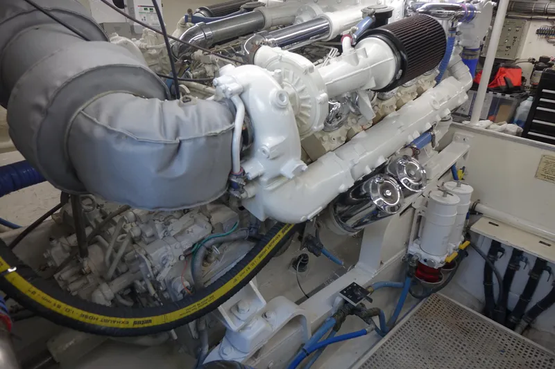 Aquila II Yacht Photos Pics Engine room of a 1990 Bertram 50 Convertible yacht, showcasing detailed machinery.