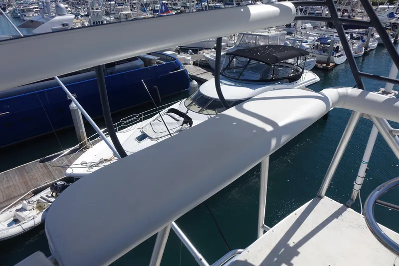 Aquila II Yacht Photos Pics Bertram 50 Convertible 1990 yacht docked in a marina, surrounded by other boats.