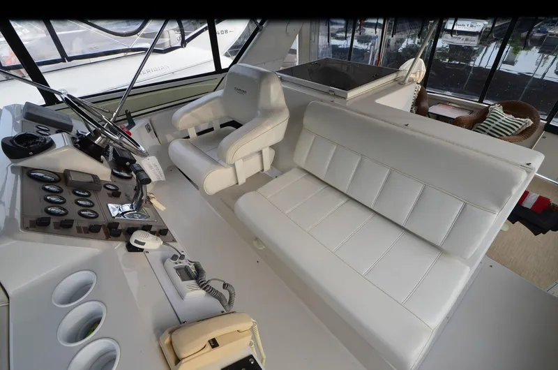 Radio Wave Yacht Photos Pics Interior of 2001 Carver 406 yacht with white leather seating and control panel.