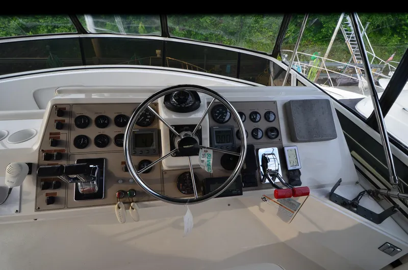 Radio Wave Yacht Photos Pics Control panel of a 2001 Carver 406 yacht with steering wheel and gauges.