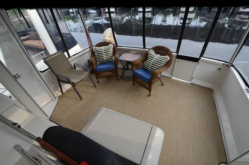 Radio Wave Yacht Photos Pics Spacious 2001 Carver 406 yacht interior with wicker chairs and marina view.