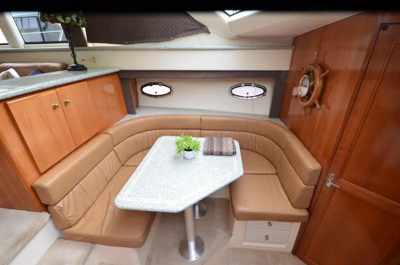 Radio Wave Yacht Photos Pics Luxurious interior of a 2001 Carver 406 yacht with a cozy dining area.