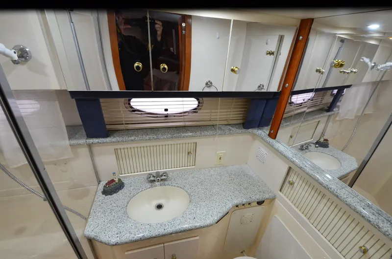 Radio Wave Yacht Photos Pics Bathroom interior of 2001 Carver 406 yacht with granite countertop and mirrored cabinets.