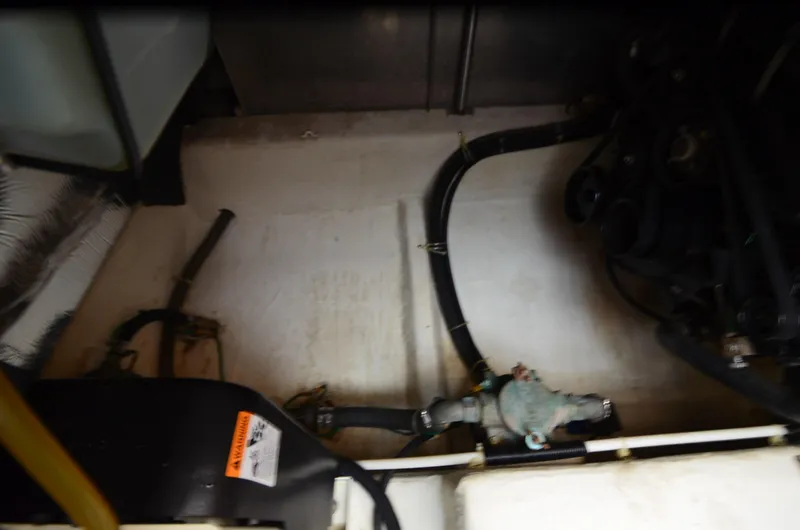 Radio Wave Yacht Photos Pics Engine compartment of a 2001 Carver 406 boat, showing hoses and mechanical components.