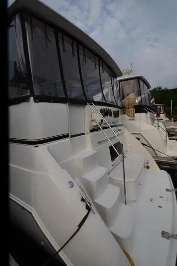 Radio Wave Yacht Photos Pics 2001 Carver 406 yacht with white exterior and covered deck, docked at marina.