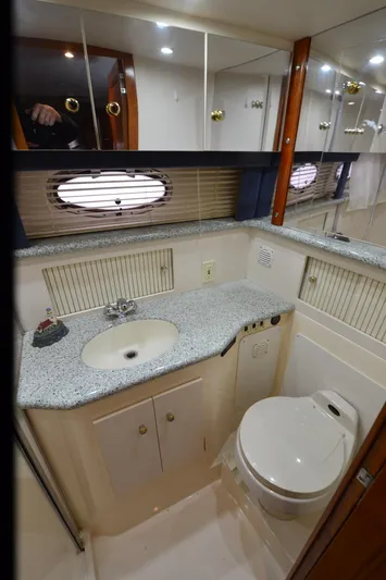 Radio Wave Yacht Photos Pics 2001 Carver 406 yacht bathroom with sink, toilet, and mirrored cabinets.