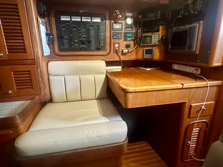 Joy Yacht Photos Pics Navigation station in 1999 Passport Royal 43 yacht with control panels and seating.