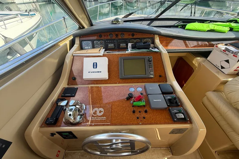  Yacht Photos Pics Control panel of a 2003 Ferretti Yachts 530, featuring navigation equipment and controls.