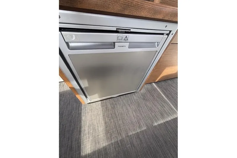 Yacht Photos Pics Compact refrigerator in 2021 Jeanneau NC Sport 895 boat interior.