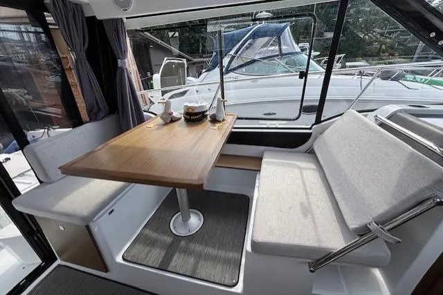  Yacht Photos Pics Interior of 2021 Jeanneau NC Sport 895 with dining area and large windows.