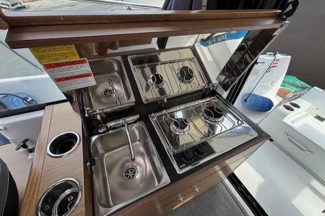  Yacht Photos Pics 2021 Jeanneau NC Sport 895 boat kitchen with dual sinks and gas stoves.