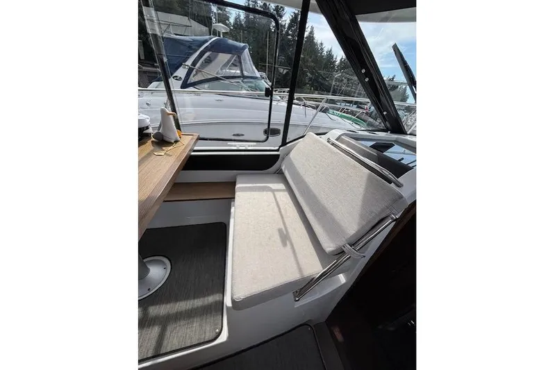  Yacht Photos Pics Interior of 2021 Jeanneau NC Sport 895 boat with seating and table.