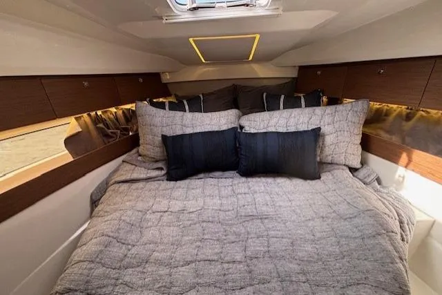  Yacht Photos Pics 2021 Jeanneau NC Sport 895 cabin interior with cozy bedding and modern design.