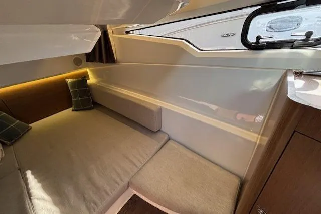  Yacht Photos Pics 2021 Jeanneau NC Sport 895 cabin interior with cozy seating and modern design.