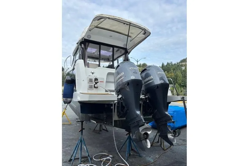  Yacht Photos Pics 2021 Jeanneau NC Sport 895 with dual Yamaha outboard motors on stands.