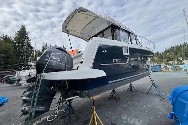  Yacht Photos Pics 2021 Jeanneau NC Sport 895 boat on stands, featuring Yamaha outboard motor.