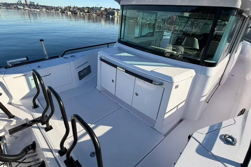  Yacht Photos Pics 2022 Axopar 37 XC Cross Cabin boat deck with sleek design and waterfront view.