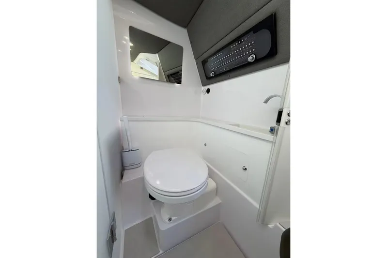  Yacht Photos Pics 2022 Axopar 37 XC Cross Cabin bathroom with modern fixtures and sleek design.