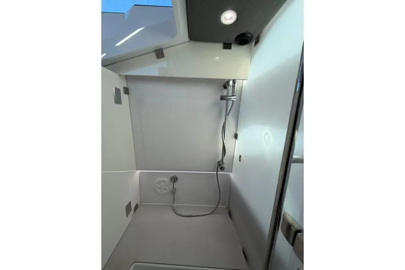  Yacht Photos Pics Shower area in 2022 Axopar 37 XC Cross Cabin boat, featuring modern fixtures and sleek design.