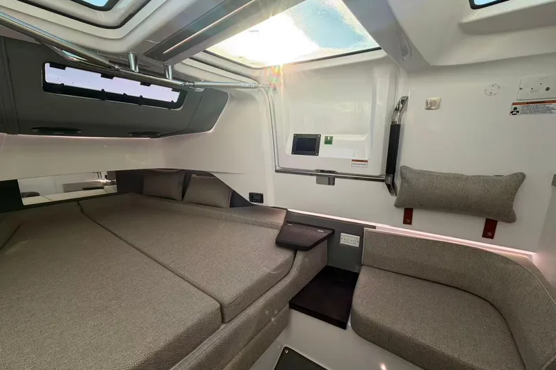  Yacht Photos Pics 2022 Axopar 37 XC Cross Cabin interior with modern seating and bedding.