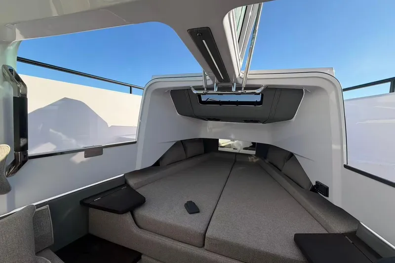  Yacht Photos Pics 2022 Axopar 37 XC Cross Cabin interior with modern seating and sleek design.