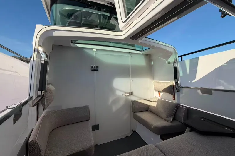  Yacht Photos Pics 2022 Axopar 37 XC Cross Cabin interior with modern seating and panoramic windows.