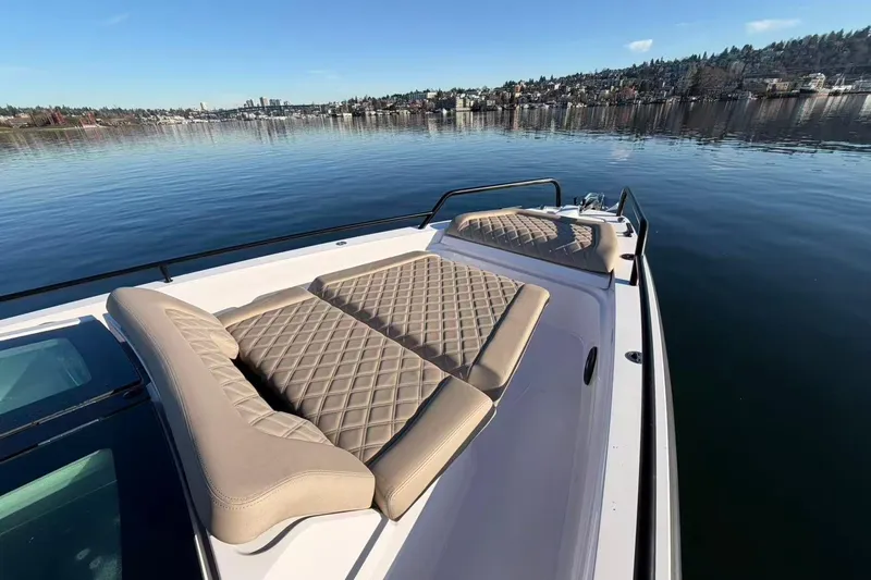  Yacht Photos Pics 2022 Axopar 37 XC Cross Cabin boat with cushioned deck, on calm water.