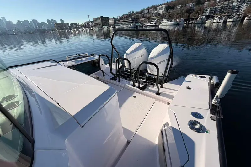  Yacht Photos Pics 2022 Axopar 37 XC Cross Cabin with twin Mercury engines on a calm waterfront.