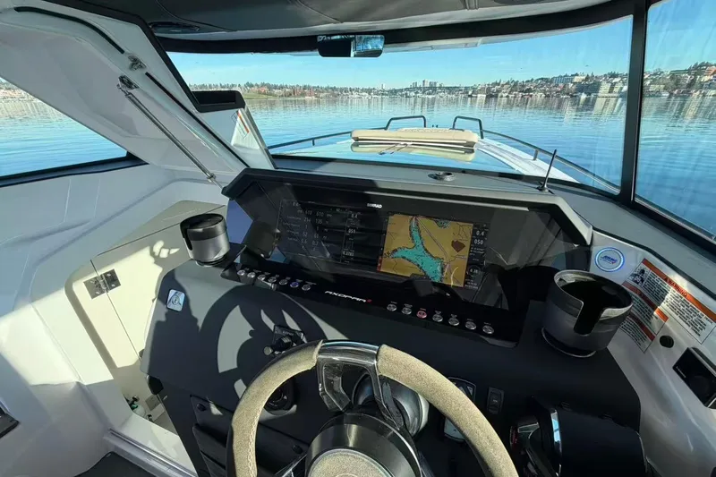  Yacht Photos Pics Interior view of 2022 Axopar 37 XC Cross Cabin boat cockpit with navigation display.