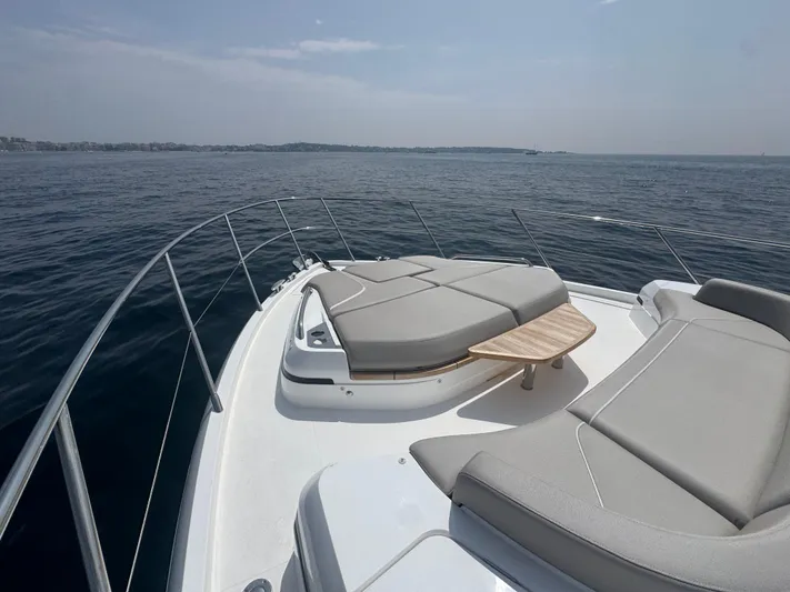  Yacht Photos Pics 2024 Princess V55 yacht deck with luxurious seating and ocean view.