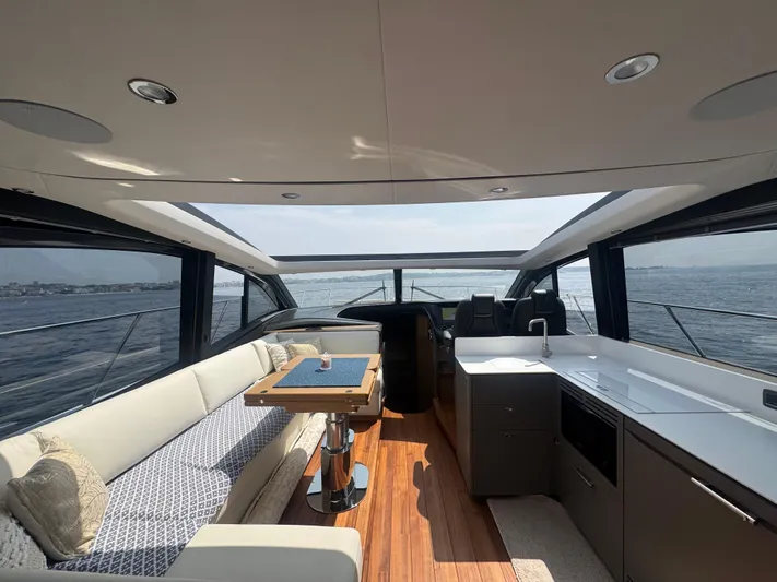  Yacht Photos Pics Luxurious interior of 2024 Princess V55 yacht with elegant seating and ocean view.