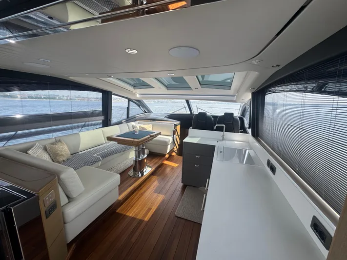  Yacht Photos Pics Luxurious interior of 2024 Princess V55 yacht with modern seating and panoramic windows.
