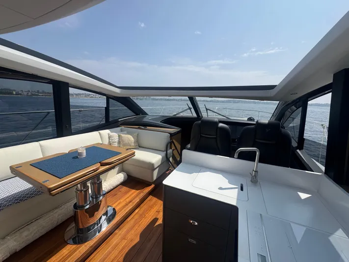  Yacht Photos Pics Luxurious interior of 2024 Princess V55 yacht with elegant seating and panoramic windows.