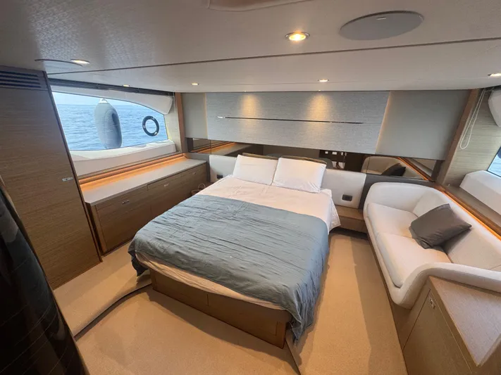  Yacht Photos Pics Luxurious 2024 Princess V55 yacht bedroom with ocean view, modern design, and elegant furnishings.