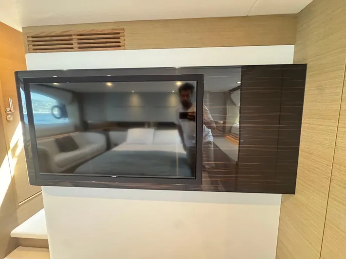  Yacht Photos Pics 2024 Princess V55 yacht interior with modern TV and luxurious bedroom reflection.