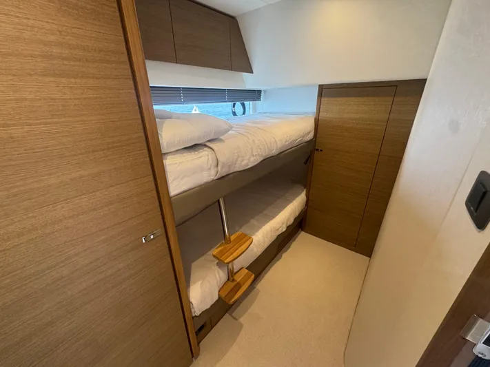  Yacht Photos Pics 2024 Princess V55 yacht interior with wooden bunk beds and modern design.