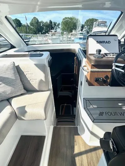Three Beaches Yacht Photos Pics Interior of 2020 Four Winns Vista 355 Coupe OB with seating and navigation equipment.