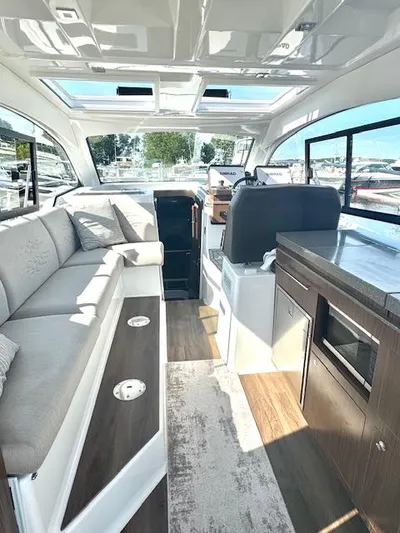 Three Beaches Yacht Photos Pics Interior of 2020 Four Winns Vista 355 Coupe OB, featuring modern seating and sleek design.