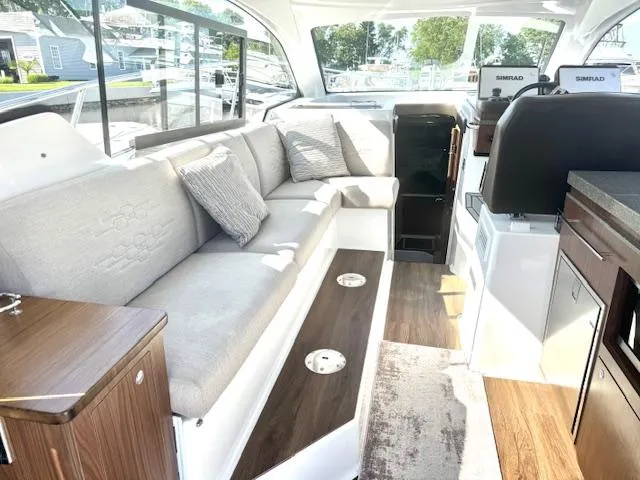 Three Beaches Yacht Photos Pics 2020 Four Winns Vista 355 Coupe OB interior with modern seating and elegant design.