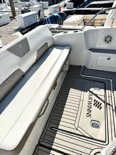 Three Beaches Yacht Photos Pics 2020 Four Winns Vista 355 Coupe OB boat interior with cushioned seating and branded flooring.