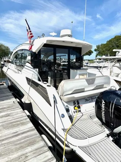 Three Beaches Yacht Photos Pics 2020 Four Winns Vista 355 Coupe OB docked, featuring sleek design and Mercury outboard engine.