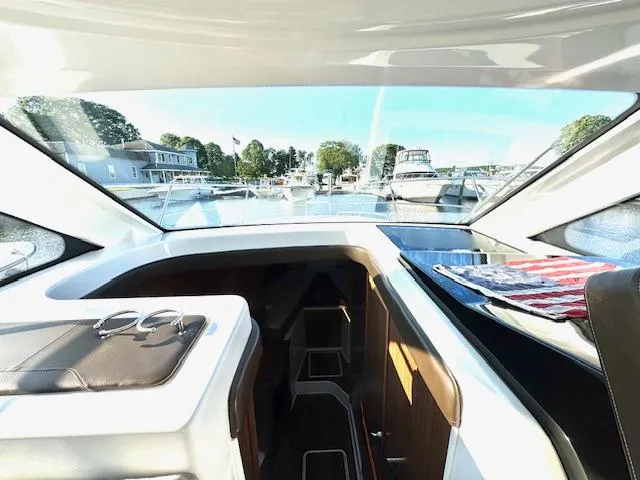 Three Beaches Yacht Photos Pics 2020 Four Winns Vista 355 Coupe OB interior with marina view, featuring sleek design and modern amenities.