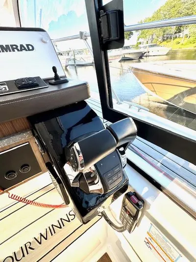 Three Beaches Yacht Photos Pics 2020 Four Winns Vista 355 Coupe OB helm with controls and view of marina.