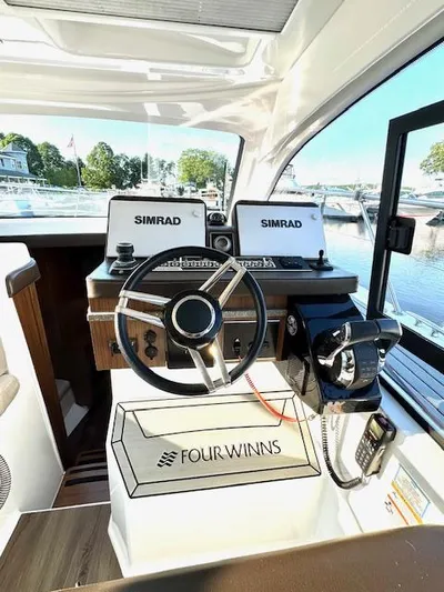 Three Beaches Yacht Photos Pics 2020 Four Winns Vista 355 Coupe OB helm with Simrad displays, docked at marina.