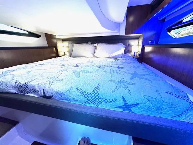 Three Beaches Yacht Photos Pics Luxurious cabin interior of 2020 Four Winns Vista 355 Coupe OB with starfish-themed bedding.